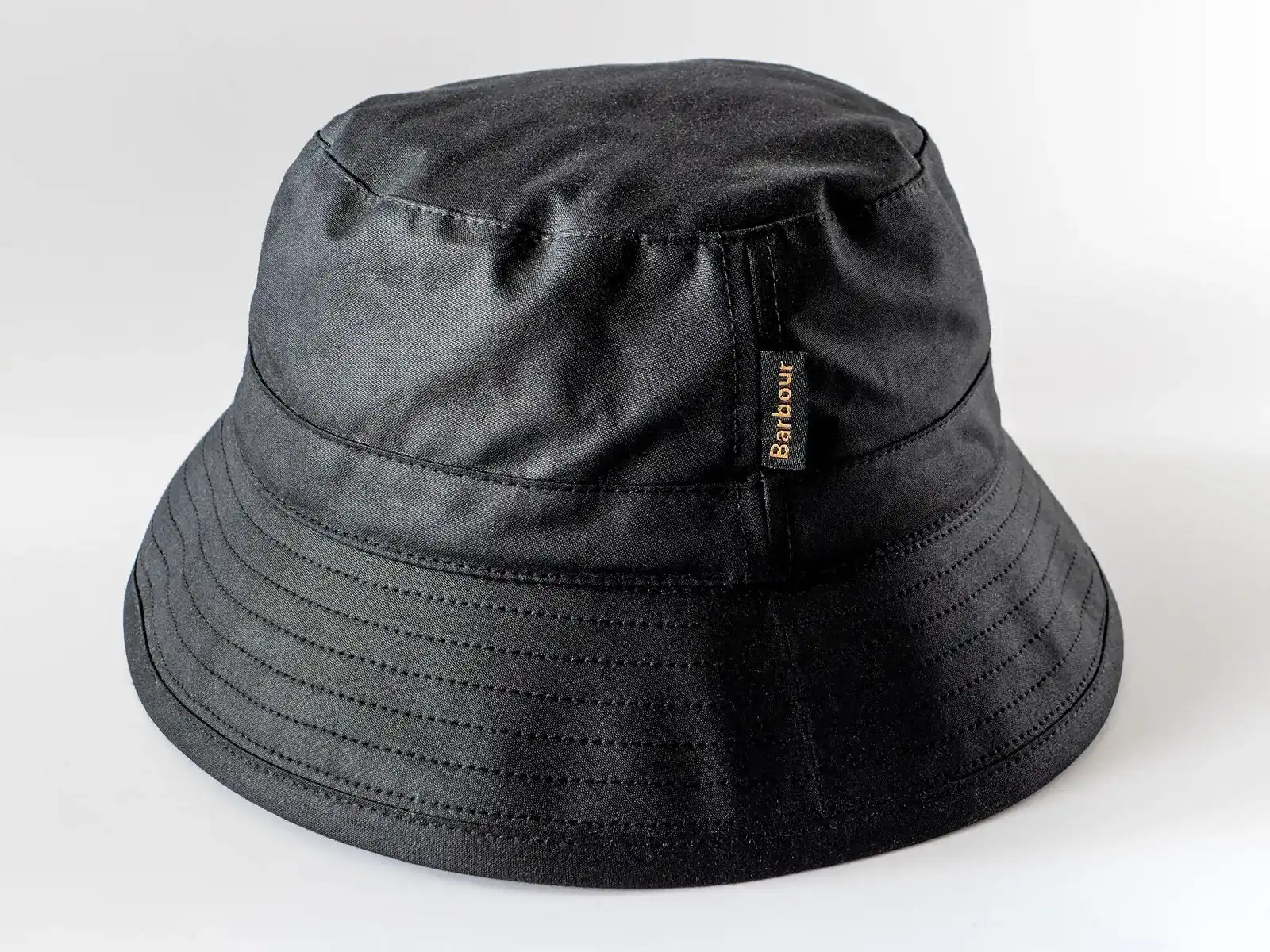 Black Barbour bucket hat made from waxed cotton fabric. Photographed in Tuntorp, Brastad, Lysekil Municipality, Sweden.